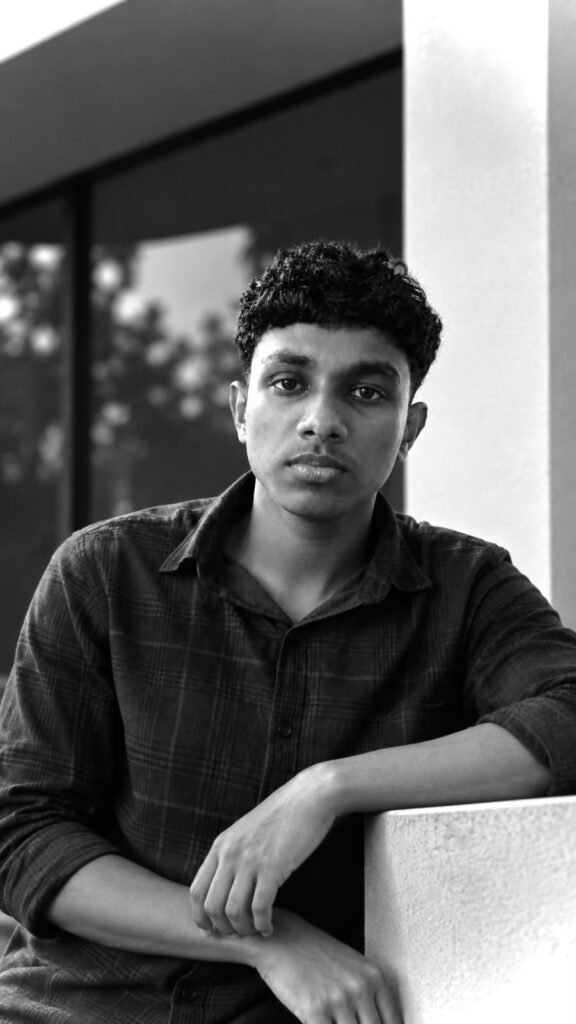 Amal, a freelance digital marketer from Malappuram, Kerala, posing confidently in a classic black and white portrait. This professional portrait represents Amal as the Best Freelance Digital Marketer in Malappuram, offering creative digital marketing services including SEO, social media marketing, website development, video editing, and graphic design.